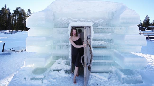 Emerging from the sauna into the snow, Finland.