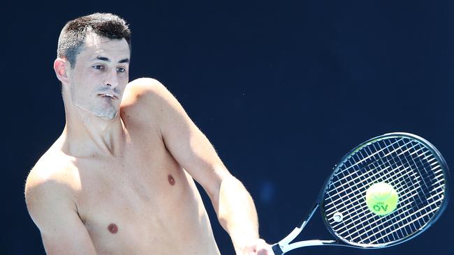 Bernard Tomic of Australia hits a backhand during a practice session ahead of the 2019 Australian Open.