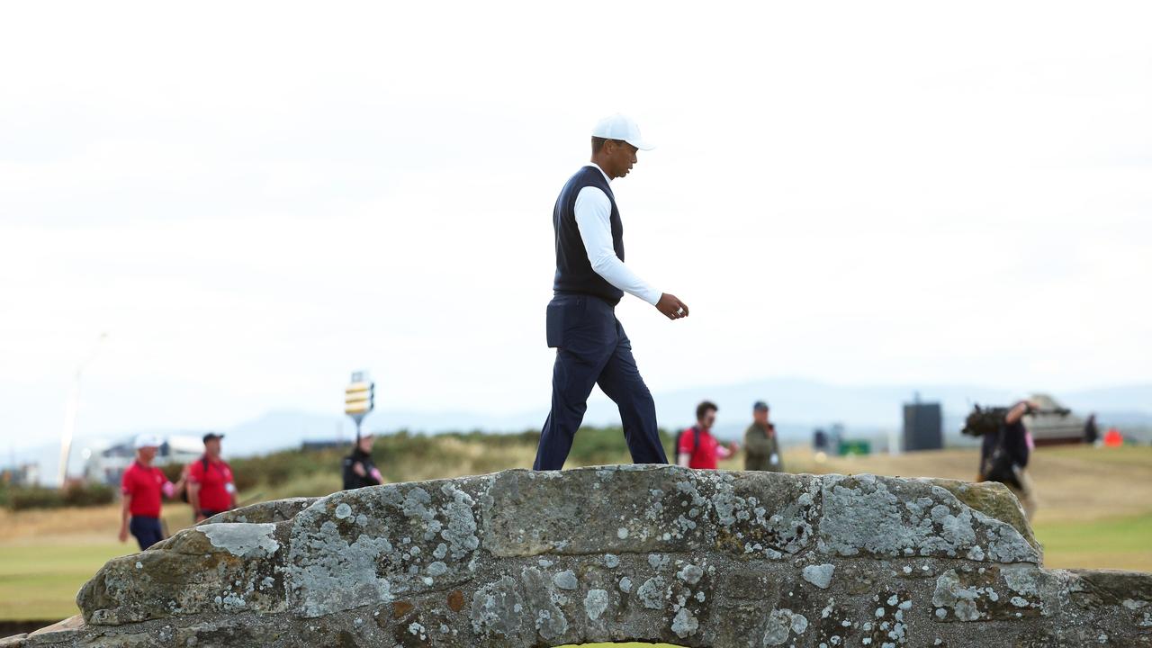 Tiger Woods walks over the Swilken Bridge on the eighteenth hole at St Andrews, Scotland. (Photo by Andrew Redington/Getty Images)