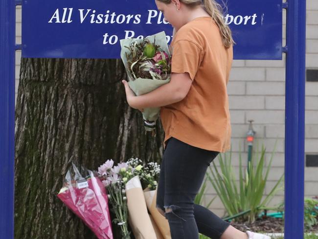 A girl leaves flowers at Baimbridge College in Hamilton. Picture: David Crosling