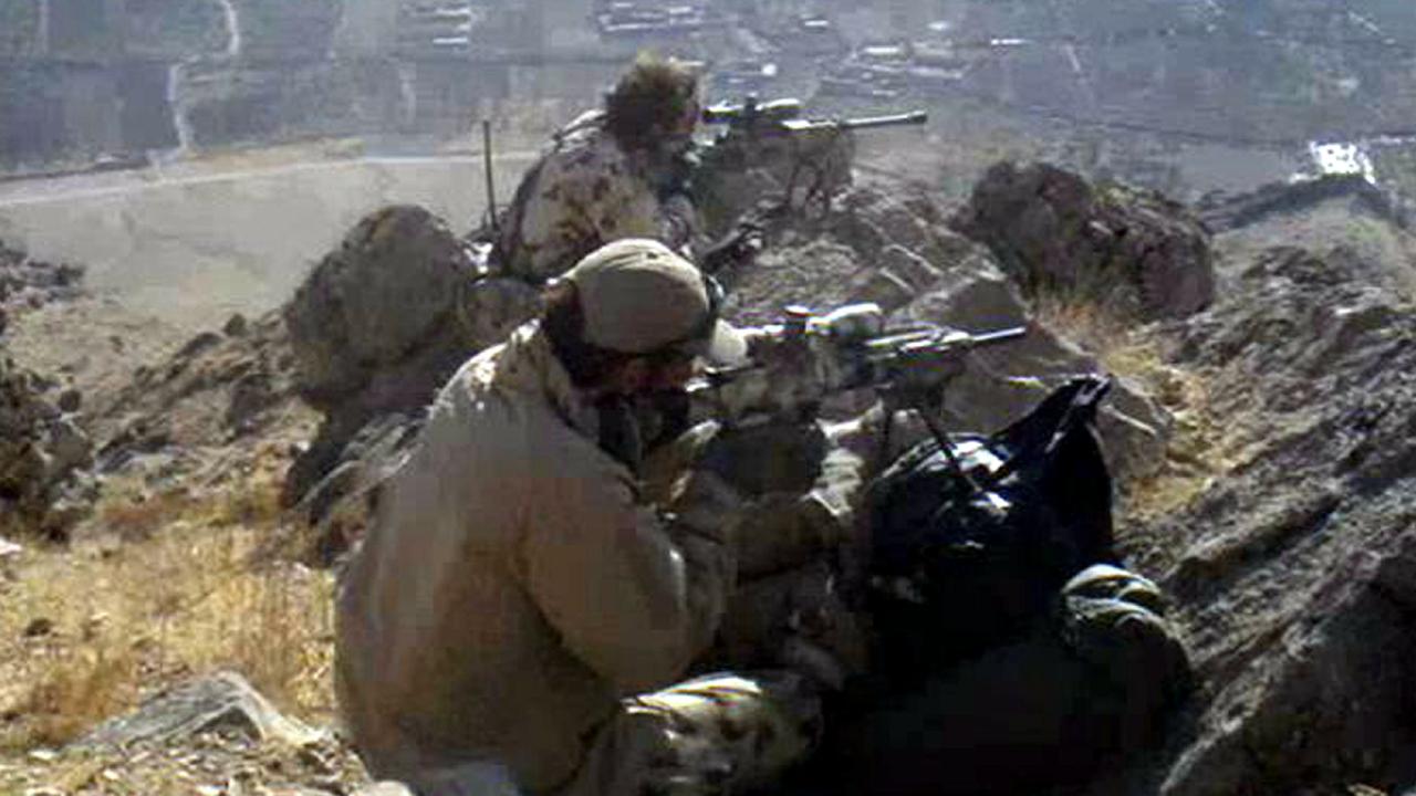 A sniper team from the 2nd Commando Regiment keeps watch for targets high above a village in the Mirabad Valley, Afghanistan.