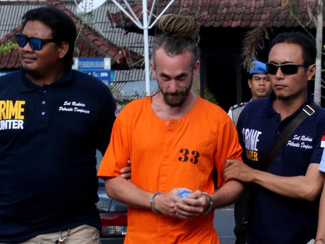 David Taylor is escorted by police back to his cell after meeting with British Consulate staff at Denpasar Police Station. Picture: Lukman S. Bintoro