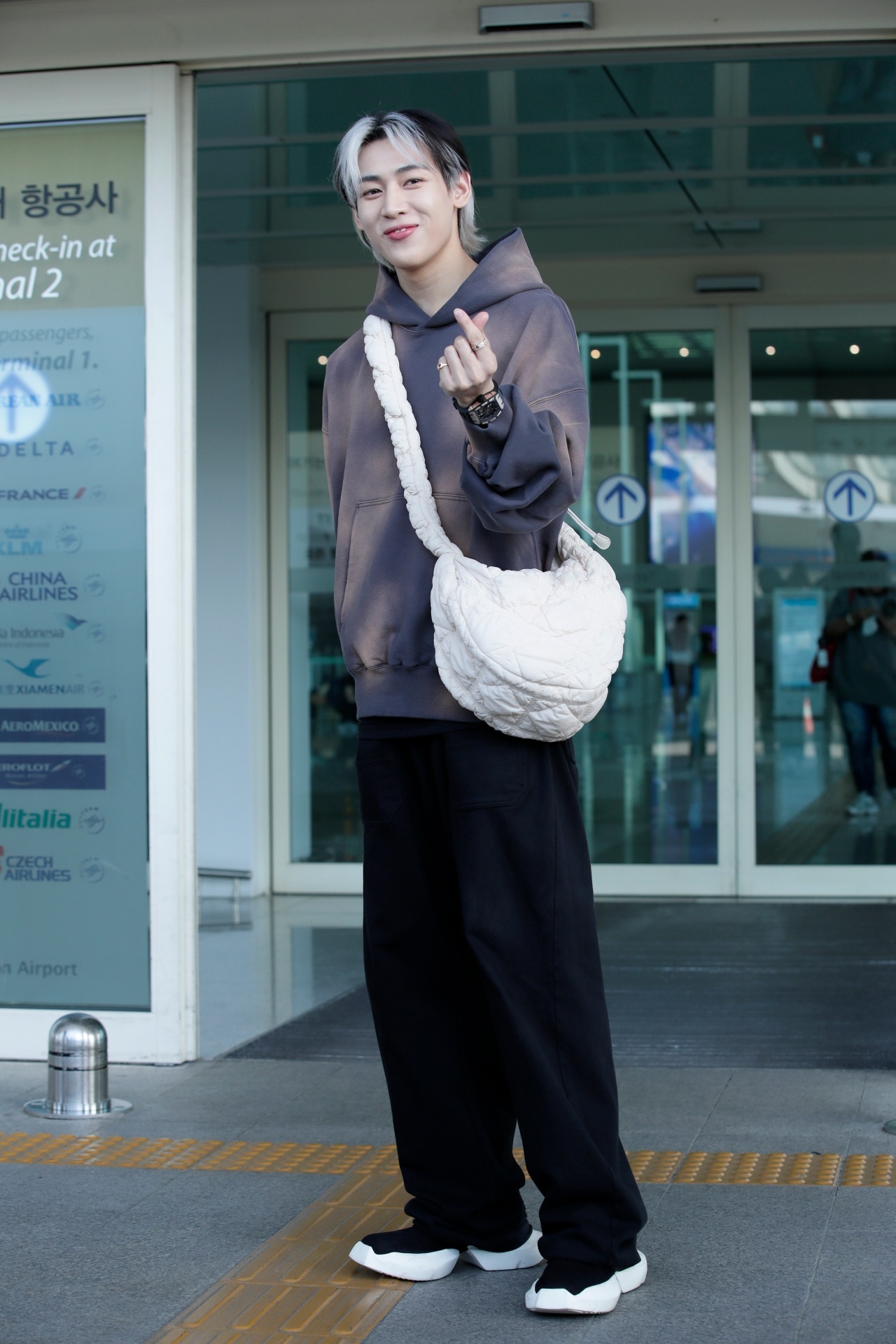 <p><em>Image credit: Getty Images</em></p><p>&nbsp;</p><p>BamBam was likely the cosiest of the stylish trio. In an oversized bleached hoodie, his quilted crossbody bag looked as if it could double as his pillow for the flight. Simple in its message, and capacious in its carrying. The overall statement was clear—the hands were free, free enough to show off his Richard Mille.</p><p><br />The utilitarian crossbody has made itself at home in countless runways. Just recently in autumn/winter ’23/’24 shows like Fear of God, Loewe, and Kenzo, to name just a few, sent models down with nifty little bags. While it is not quite the serve of the <a href="https://www.gq.com.au/style/celebrity/james-mcavoy-classy-totes/news-story/0bd7f271db7e6bb33b099c57b5f2b82c" target="_blank" rel="noopener">upgraded tote bag</a>, there’s a lot of fun to be had in carrying only the most essential of items.</p><p>&nbsp;</p><p>Really though, hands-free, easy access is the absolute minimum your crossbody bag of choice should offer. But a luxury touch makes the fit all the more complete, especially to stunt at the airport. And while it’s not quite the devilish concoction of luxury accessories and the casual flying wardrobe, who said it ever needed to be? Match your best looks, with your best accessories. The airport has a runway for a reason.</p><p>&nbsp;</p><p>Try any of these crossbody bags to take your fit to the next level</p>