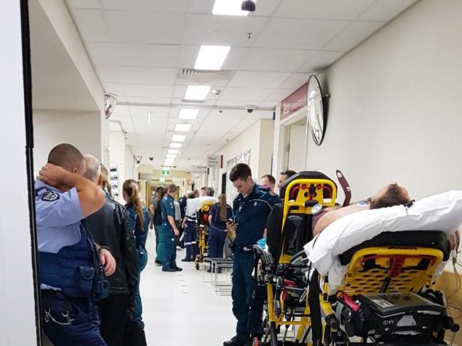 This whistleblower picture shows patients and emergency personnel waiting in a hallway at Princess Alexandra Hospital last September. Nurses say the practice is still happening. 