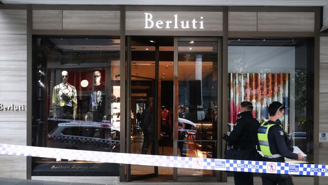 Police at the scene of a ram raid at the Berluti store in Collins Street. Picture: NCA NewsWire/ David Crosling