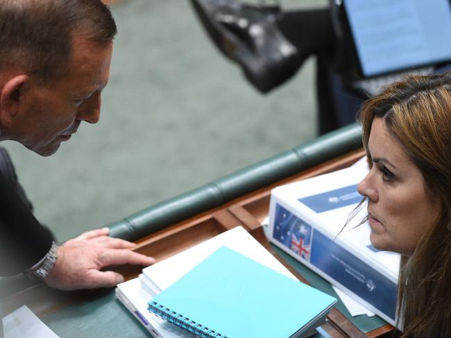 ** File** A Thursday, May 28, 2015 file photo of Australian Prime Minister Tony Abbott speaks with his Chief of Staff Peta Credlin during Question Time in the House of Representatives at Parliament House in Canberra. A new book by journalist Niki Savva, titled The Road to Ruin, says Mr Abbott was warned he would lose the prime ministership unless he dumped Ms Credlin. Saturday, March 5th, 2016. (AAP Image/Mick Tsikas) NO ARCHIVING