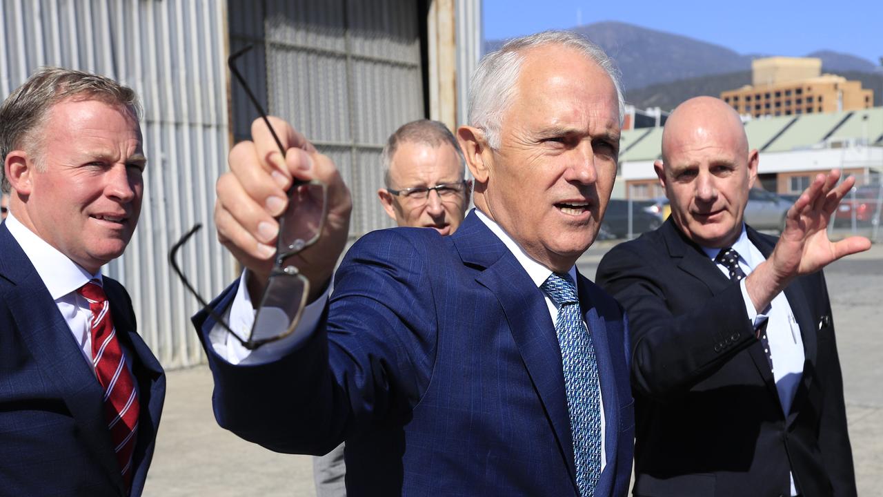 Australian Prime Minister Malcolm Turnbull (centre), with Tasmanian Premier Will Hodgman (left) and Tasmanian Minister for Planning Peter Gutwein (right) discuss the announcement of Hobart as the next City Deal at Macquarie Point in Hobart, Tasmania, Tuesday, January 16, 2018. Hobart will be the next location for the federal government's City Deal, which could see a new science and technology centre built in the Tasmanian capital. (AAP Image/Rob Blakers) NO ARCHIVING