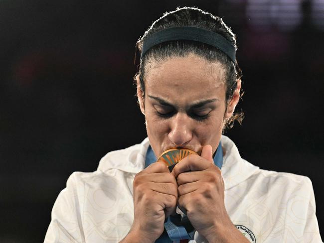 TOPSHOT - Gold medallist Algeria's Imane Khelif poses on the podium during the medal ceremony for the women's 66kg final boxing category during the Paris 2024 Olympic Games at the Roland-Garros Stadium, in Paris on August 9, 2024. (Photo by MOHD RASFAN / AFP)