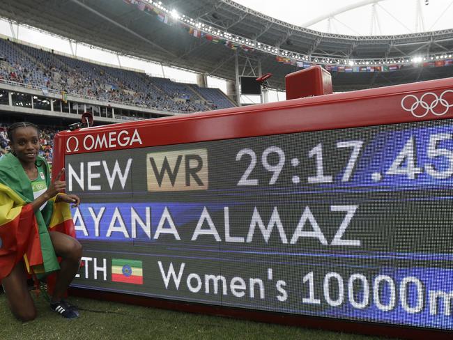 Almaz Ayana with the famous scoreboard showing her new world record. Picture: AP Photo/Matt Slocum.