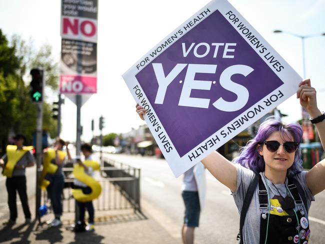 Members of the public hold yes placards as the country heads to polling stations in Dublin, Ireland. Picture: Jeff J Mitchell/Getty Images