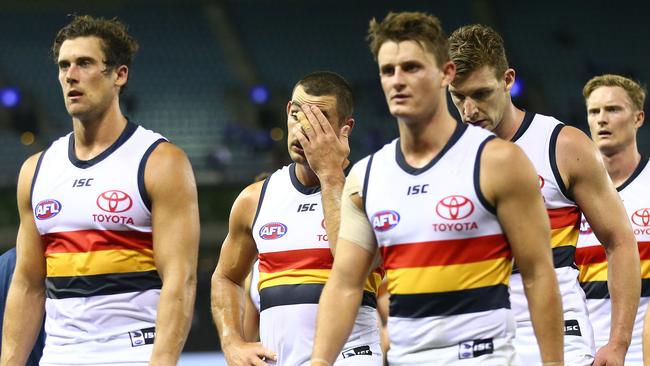 Adelaide co-captain Taylor Walker (middle) shows his frustration as the team leaves Marvel Stadium following the two-goal loss to North Melbourne on Saturday night. Picture: SCOTT BARBOUR (Getty Images).