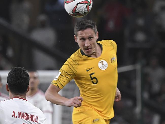 Australia's midfielder Mark Milligan vies for the ball with United Arab Emirates' forward Ali Mabkhout al Hajeri during the AFC Asian Cup quarterfinal soccer match between United Arab Emirates and Australia at Hazza Bin Zayed Stadium in Al Ain, United Arab Emirates, Friday, Jan. 25, 2019. (AP Photo/Hassan Ammar)