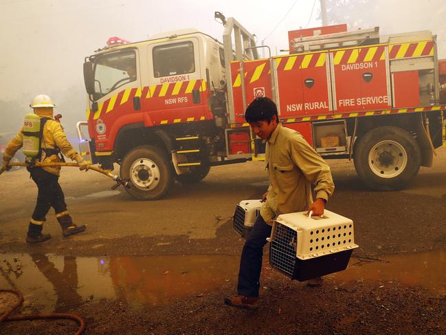 A man carrying his pets makes a last-minute escape. Picture: Sam Ruttyn