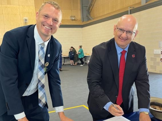 Ripley Valley State Secondary College principal, Brendan Krueger and Blair MP Shayne Neumann inspect the plans for the school's memorial.