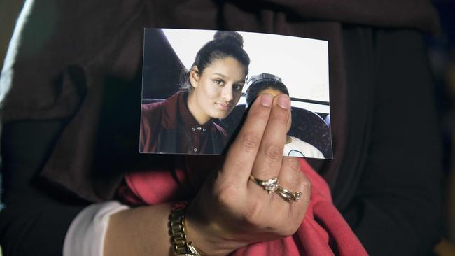 In this photo taken in 2015, Renu Begum, eldest sister of Shamima Begum, holds a picture of her sister while being interviewed by the media in central London. Picture: Laura Lean/pool/AFP