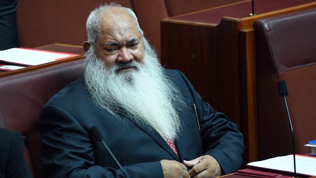 Senator Patrick Dodson, without trademark hat, takes his place on the opposition benches of the Senate yesterday