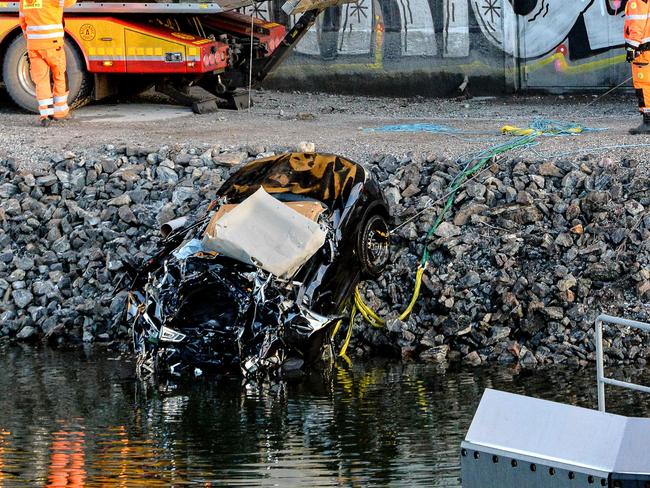 Rescue workers pull the car from the canal under the E4 highway bridge in Sodertalje. Picture: AFP/TT News Agency/Johan Nilsson