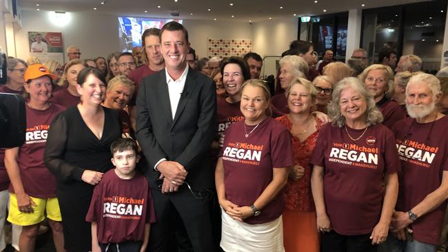 The victorious Wakehurst MP, Michael Regan, flanked by supporters at the Manly Warringah Football Club at Cromer on election night after grabbing the safe seat from the Liberals. Picture: Jim O'Rourke