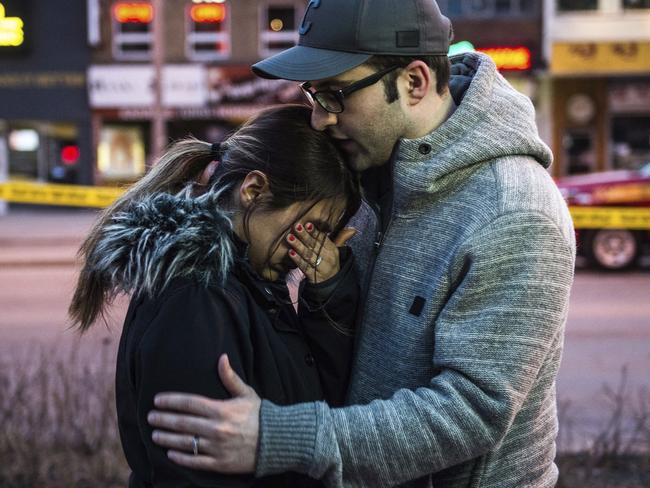 Farzad Salehi consoles his wife, Mehrsa Marjani, who was at a nearby cafe and witnessed the aftermath when a van ploughed down a crowded footpath. Picture: AP