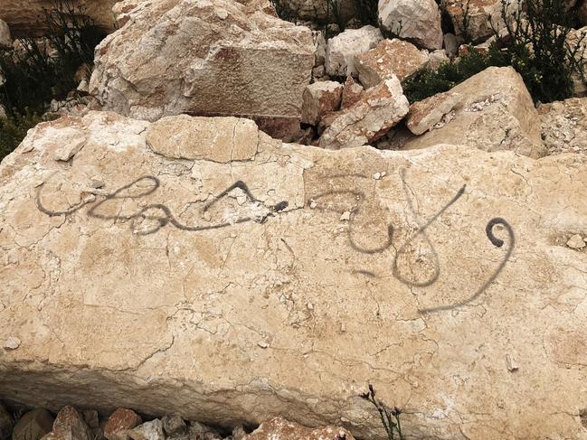 A piece of ruins at Palmyra in Syria that says "Daesh city". Picture: Ella Pellegrini