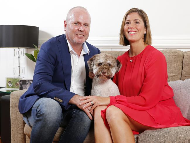 Andy and Jackie Buchanan with dog Poppy in their home in Norman Park, Brisbane. Picture: Josh Woning/AAP