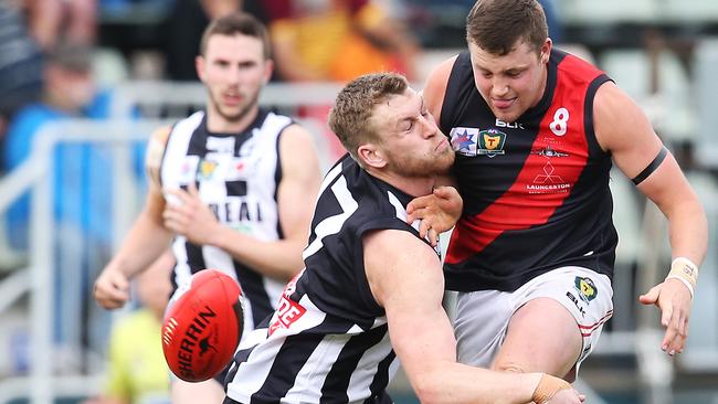 Sam Hall lays a bump on North Launceston’s Zachary Burt in today’s TSL Grand Final at Blundstone Arena. Picture: Nikki Davis-Jones