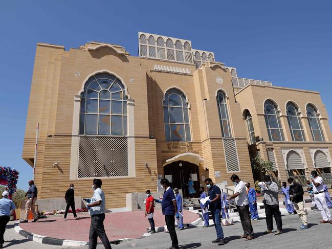 Members of Dubai's Indian community queue to receive their shot of China's Sinopharm COVID-19 vaccine at a Sikh temple in Dubai. Picture: AFP