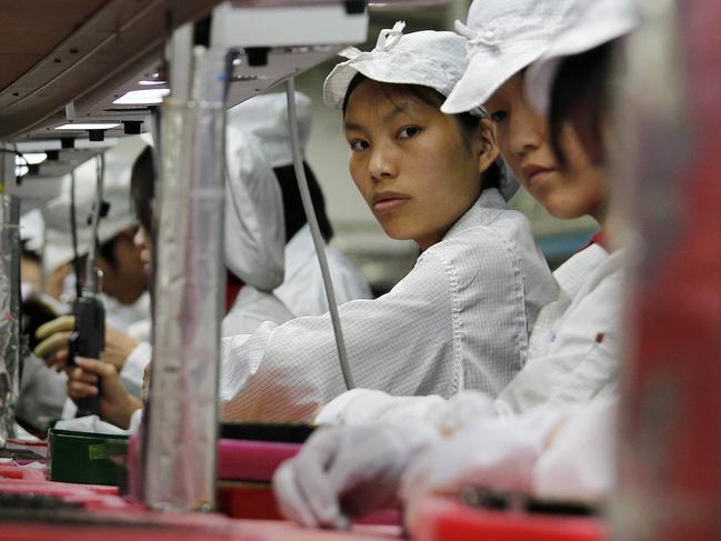 Workers inside a Foxconn factory in the township of Longhua in the southern Guangdong province in this file photo. PHOTO: REUTERS