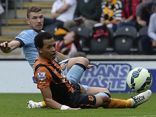 Edin Dzeko slides in to score City’s third.