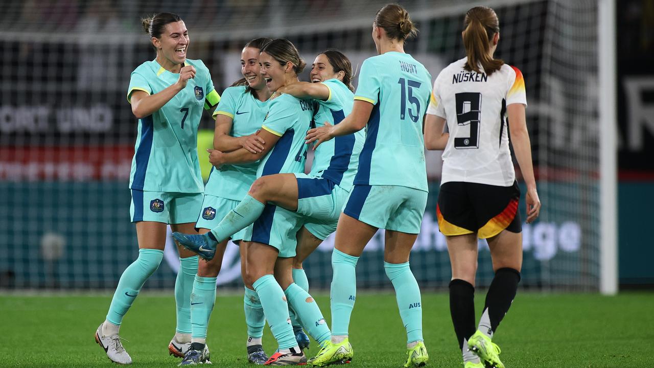 The Matildas’ Kyra Cooney-Cross is embraced by teammates after scoring Australia’s first goal during the international friendly match between Germany and Australia at Schauinsland-Reisen-Arena on October 28, 2024 in Duisburg, Germany. Picture: Alex Grimm/Getty Images