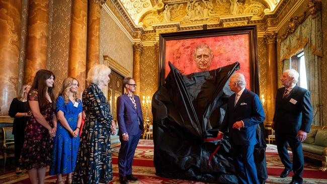 Queen Camilla watches as King Charles III unveils the official portrait of himself, by artist Jonathan Yeo, left of the painting. Picture: Pool/AFP