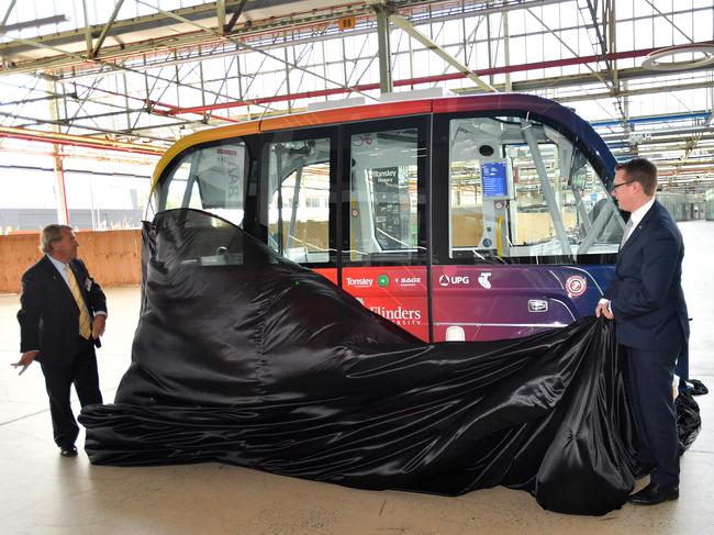 Flinders University chancellor Stephen Gerlach and Transport Minister Stephan Knoll unveiling the shuttle. (Picture: AAP/David Mariuz)