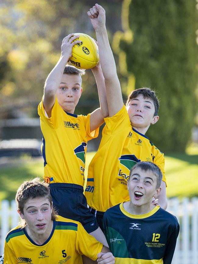 Levi Storti practises his high-flying marking at Eagles training over teammates Cooper Aiello, Seth Benke and Jake Neilson. Picture: Mark Brake