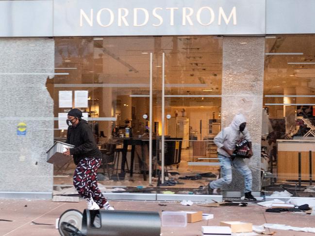 People are seen looting stores at the Grove shopping centre in the Fairfax District of Los Angeles. Picture: AFP