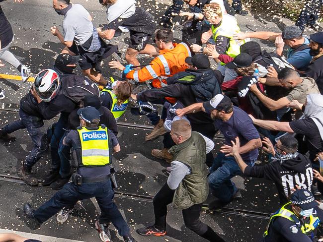 1 0F 8 SEQUENCE OF A MAN CHARGING A FEMALE POLICE OFFICER. World Wide Rally For Freedom protest September 18, 2021. Protesters meet a huge police presence in Richmond, blocking off the CBD with a ring of steel. Picture: Jason Edwards