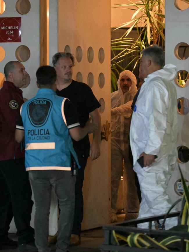 Forensic workers and police officers work at the hotel where Payne died. Picture: Juan Mabromata / AFP