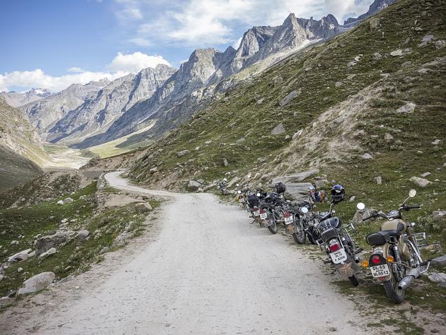 Extreme Bike Tours group makes its way through a valley flanked by imposing mountains in India’s north.