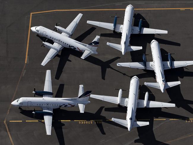 SYDNEY, AUSTRALIA - APRIL 22: An aerial view of Rex Airlines aircraft at Sydney Airport on April 22, 2020 in Sydney, Australia. Restrictions have been placed on all non-essential business and strict social distancing rules are in place across Australia in response to the COVID-19 pandemic.  (Photo by Ryan Pierse/Getty Images)