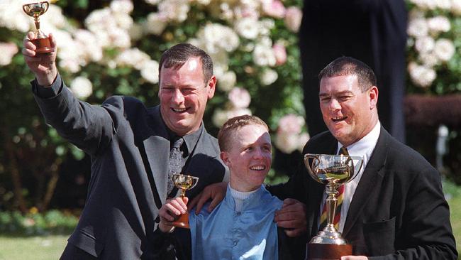 Michael Moroney celebrating Brew’s Melbourne Cup win in 2000 with jockey Kerrin McEvoy and part-owner Paul Moroney. Picture: Colleen Petch