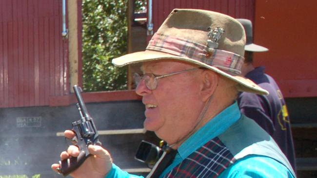 Convicted murderer Phillip Tonal Scott with guns holding up the Mary Valley Rattler. Photo / The Gympie Times