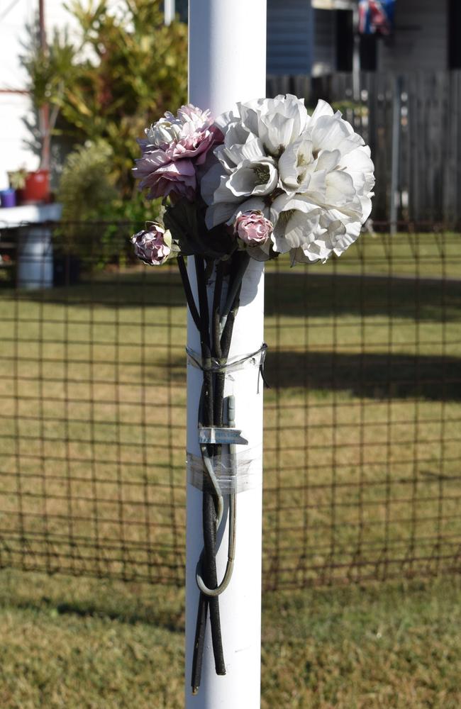 Flowers on the street sign at Bean St, Park Avenue. Picture: Aden Stokes