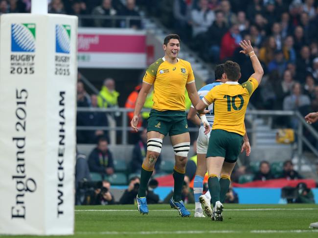 Rob Simmons (L) celebrates with Bernard Foley after scoring the opening try during the 2015 Rugby World Cup semi-final match against Argentina.
