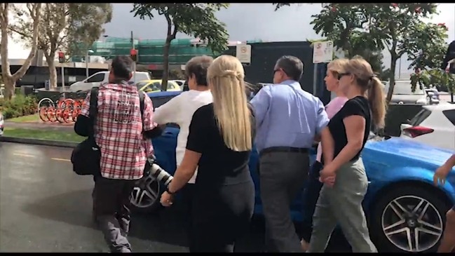 Supporter confronts photographer leaving court