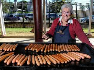 HAPPY HELPER: Rita Langer cooking up a treat at her familiar Blair State School barbecue. Picture: Rob Williams