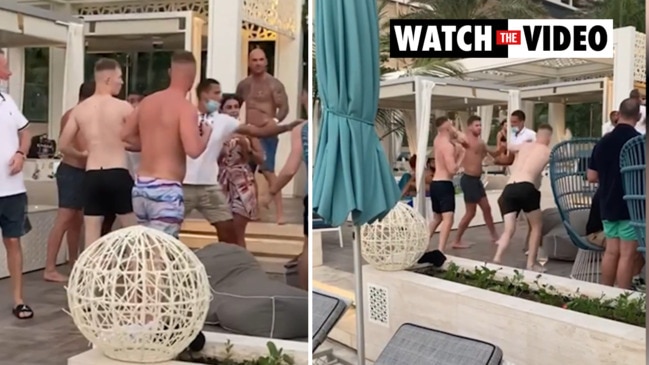 Ex bikie boss Mark Buddle spits at a group of men in Dubai