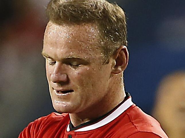 Manchester United forward Wayne Rooney (L) reacts after missing a goal against Paris Saint-Germain during the second half of their International Champions Cup soccer game at Soldier Field in in Chicago, Illinois on July 29, 2015. AFP PHOTO/ JOSHUA LOTT