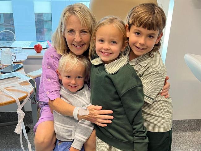 Julie Dignum, 65, with Rasta Dignum, 3, Pippi Dignum, 6, and Dusty Dignum, 8, visiting their grandmother in hospital after Baz the foster dog and his now-new owners was credited with helping save her life. Picture: Supplied