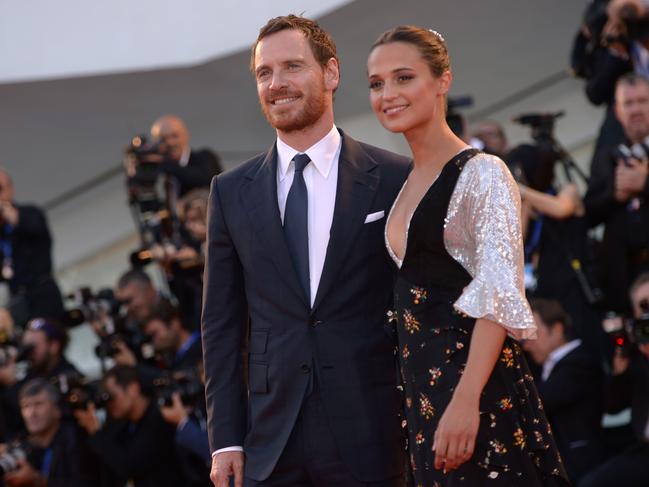 Michael Fassbender and Alicia Vikander pose on the red carpet as they arrive for the premiere of the movie “The Light Between Oceans” presented in competition at the 73rd Venice Film Festival on September 1, 2016. Picture: AFP