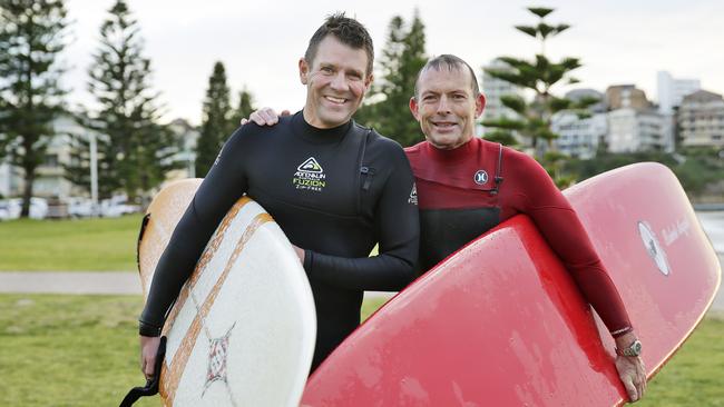 Tony Abbott and Mike Baird surfing at Manly Beach. Picture: Braden Fastier