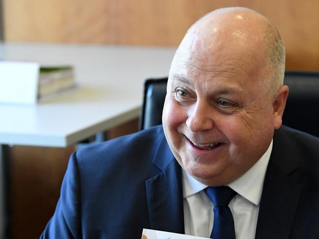 Victorian Treasurer Tim Pallas holds the first copy of the 2018/19 Victorian budget at his office in Melbourne. Picture: AAP.